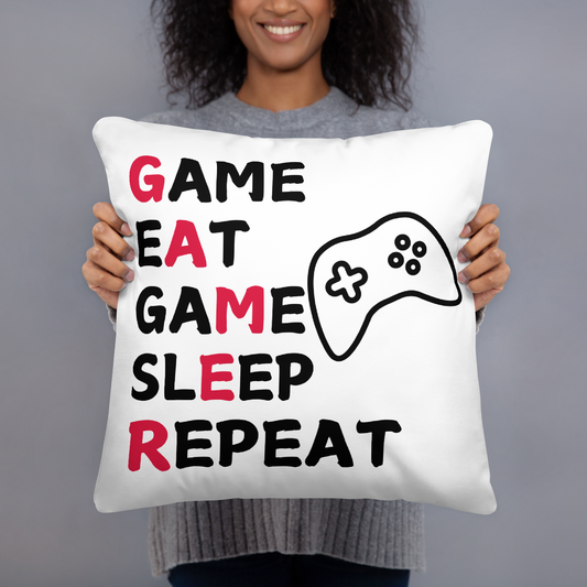 White pillow with Game Eat Game Sleep Repeat wording and black game controller image