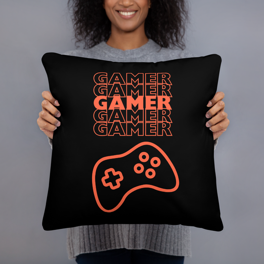 Black pillow with the word Gamer repeated 5 times in orange and an image of an orange-colored game controller