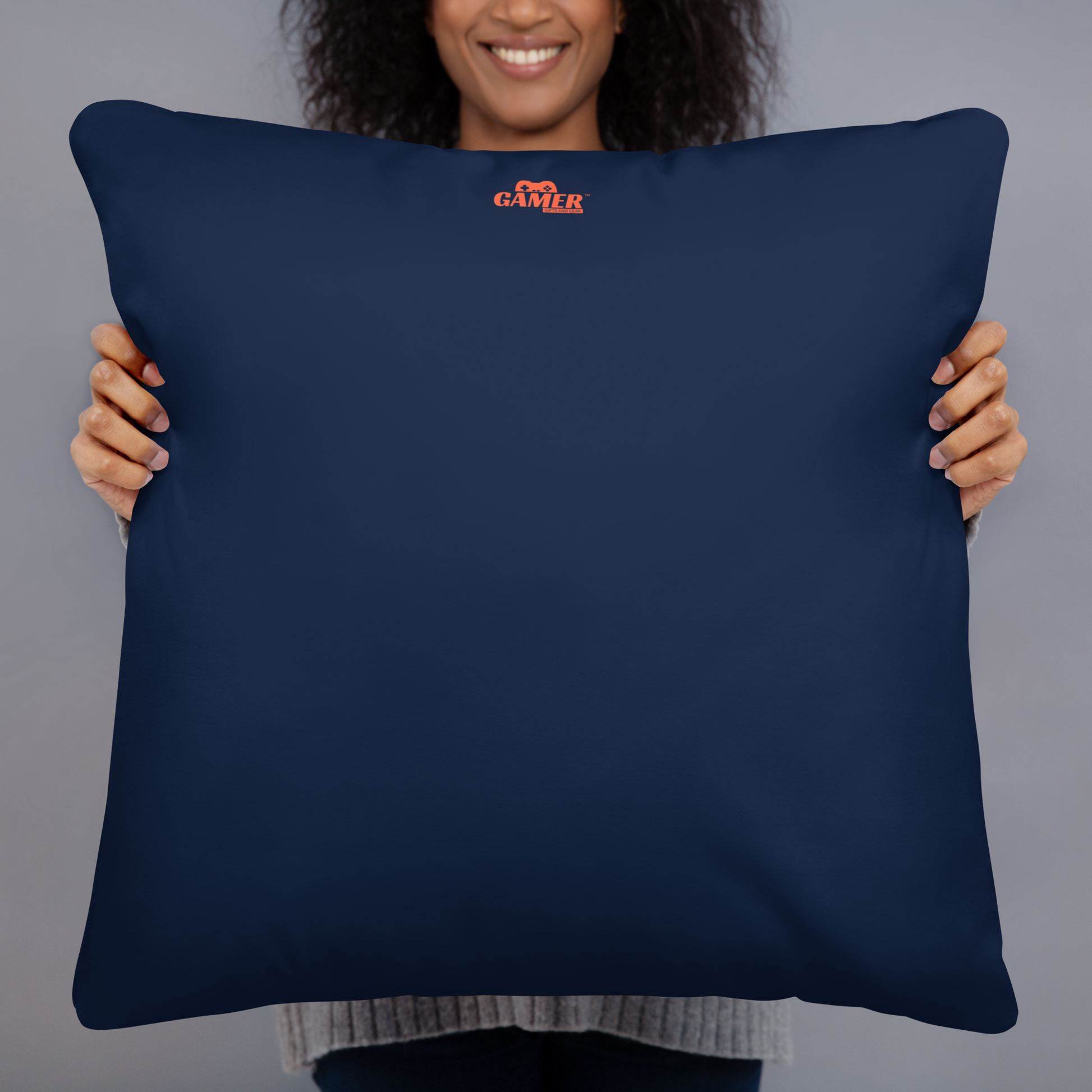 Back of blue pillow with an orange colored Gamer Gifts and Gear logo