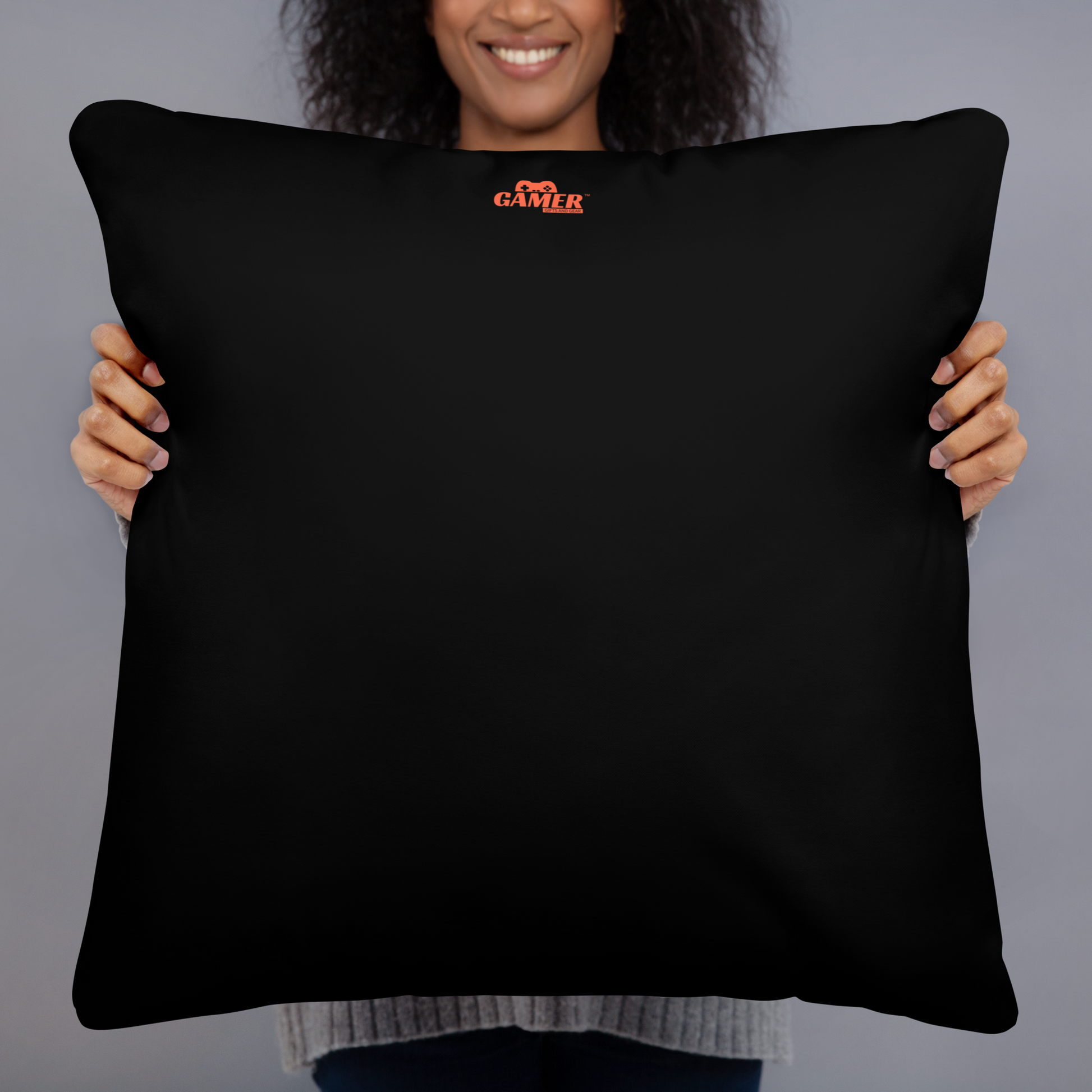 Back of black pillow with orange colored Gamer Gifts and Gear Logo