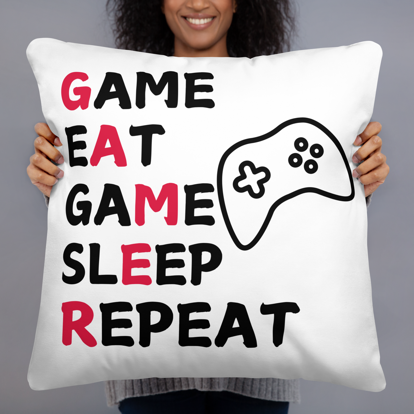 White pillow with Game Eat Game Sleep Repeat wording and black game controller image